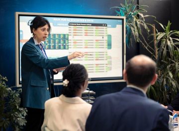 office-manager-presenting-data-analysis-funding-interactive-board_482257-97967